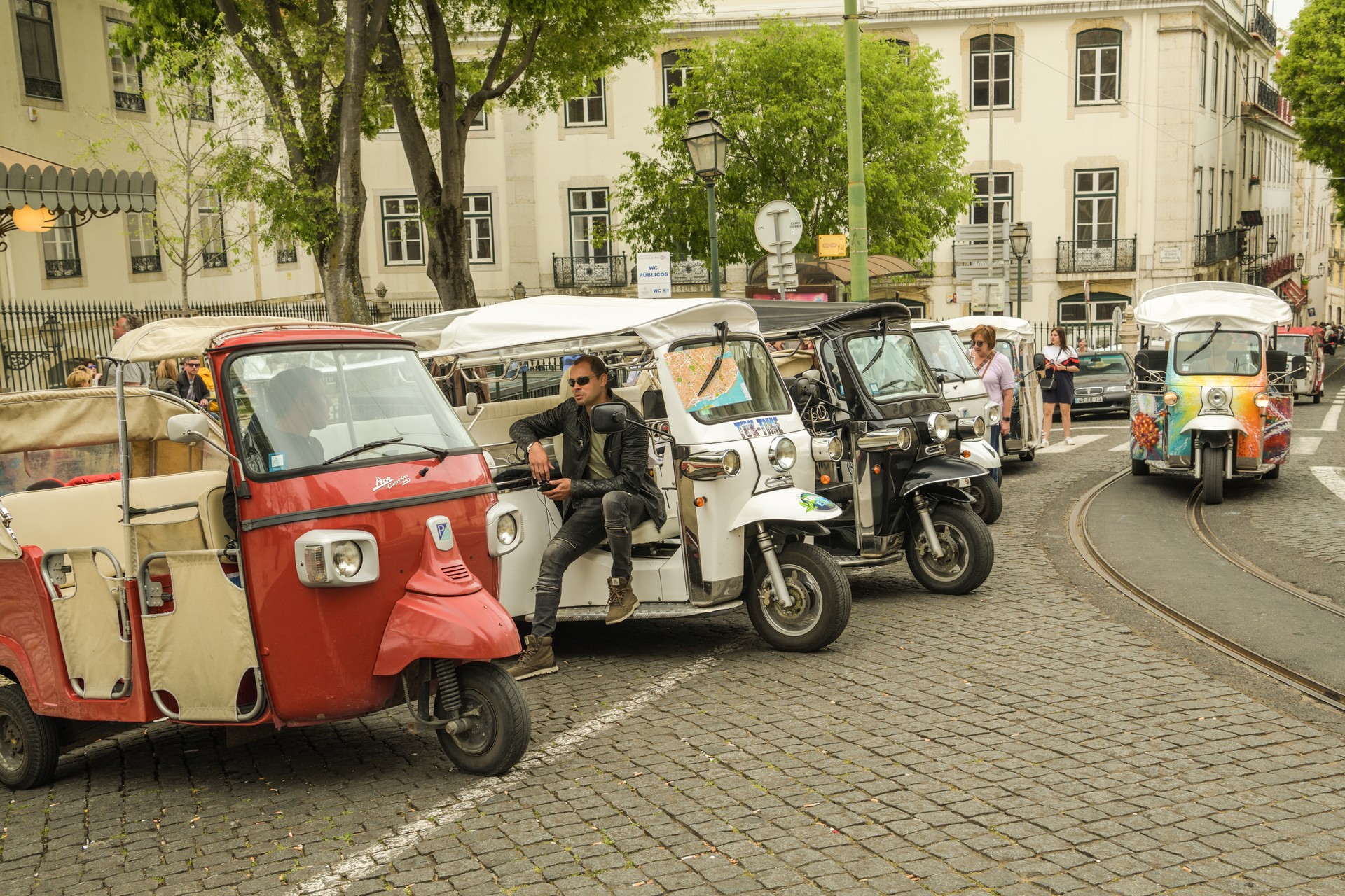 Tuk tuk driver waiting for his next customer in front of Lisbon Cathedral